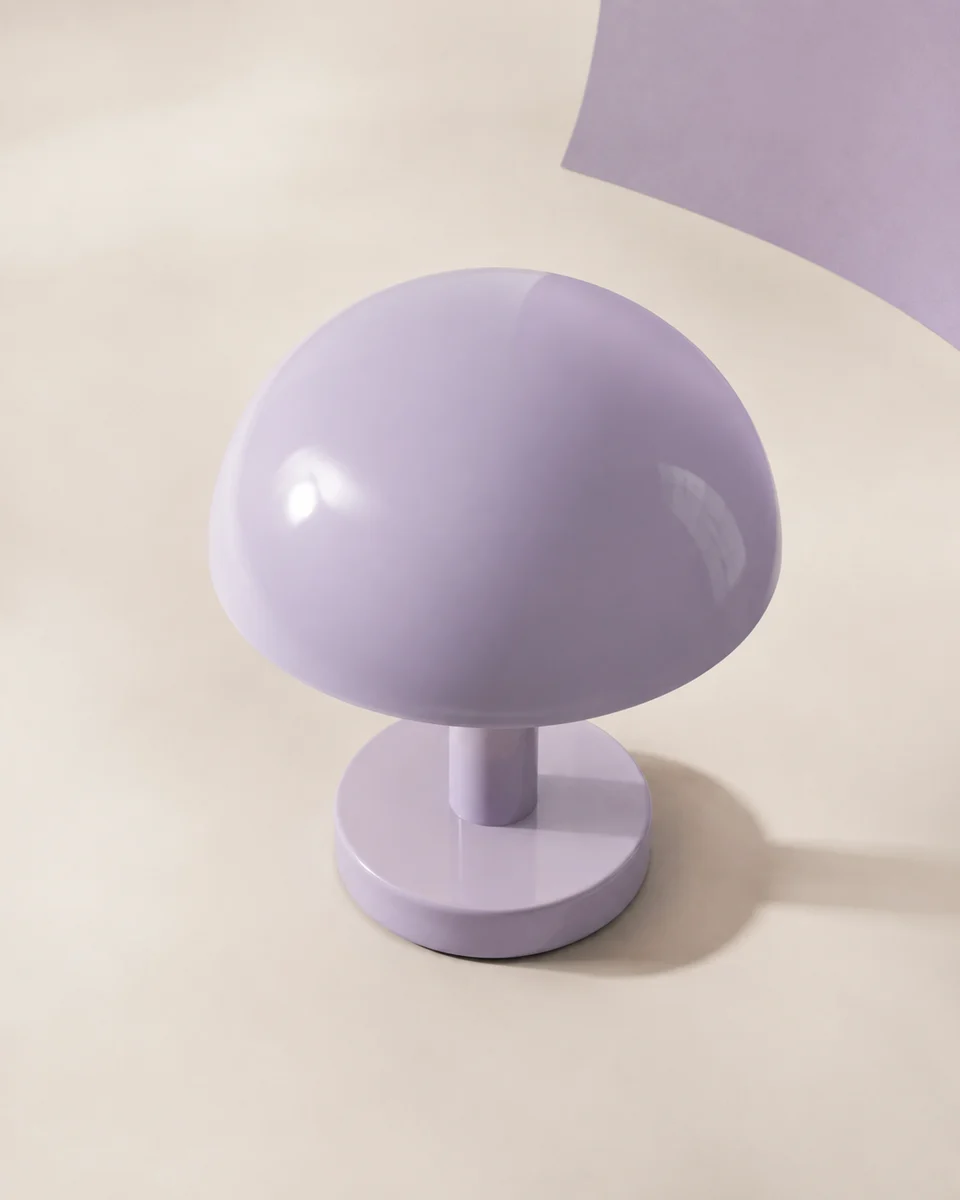 An elevated view of a lilac lamp showing the curved shade and circular base